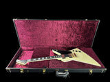 Electric guitar in a purple-lined case on a gray background