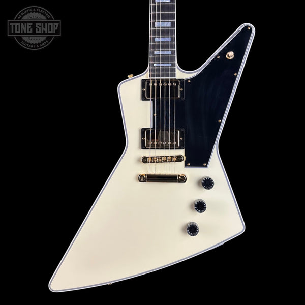 White electric guitar with black pickguard on a black background, featuring 'Tone Shop' logo.