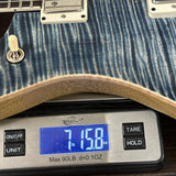 Guitar on a digital scale displaying weight