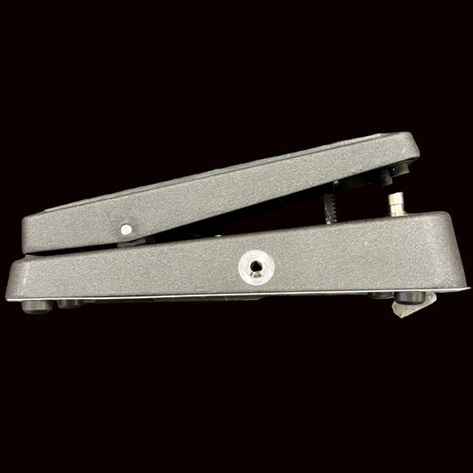 Metal foot pedal on a textured gray background