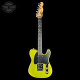 A bright yellow electric guitar with a black pickguard and maple headstock, shown against a solid black background. A Tone Shop watermark is visible in the top-left corner.