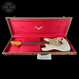 White Electric guitar in brown case with red interior. 