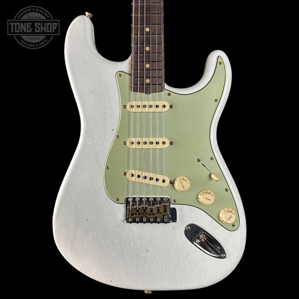 White electric guitar with green pickguard on a black background, featuring 'Tone Shop' logo.