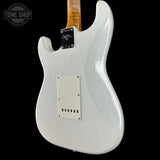 White electric guitar with a visible brand logo on a black background
