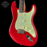 Red electric guitar with a visible brand logo on a black background