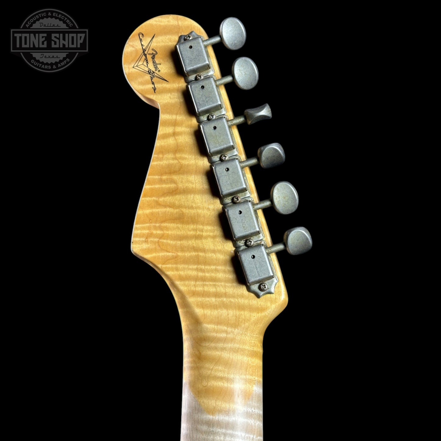 Guitar headstock with tuning pegs on a black background, featuring the Tone Shop logo.