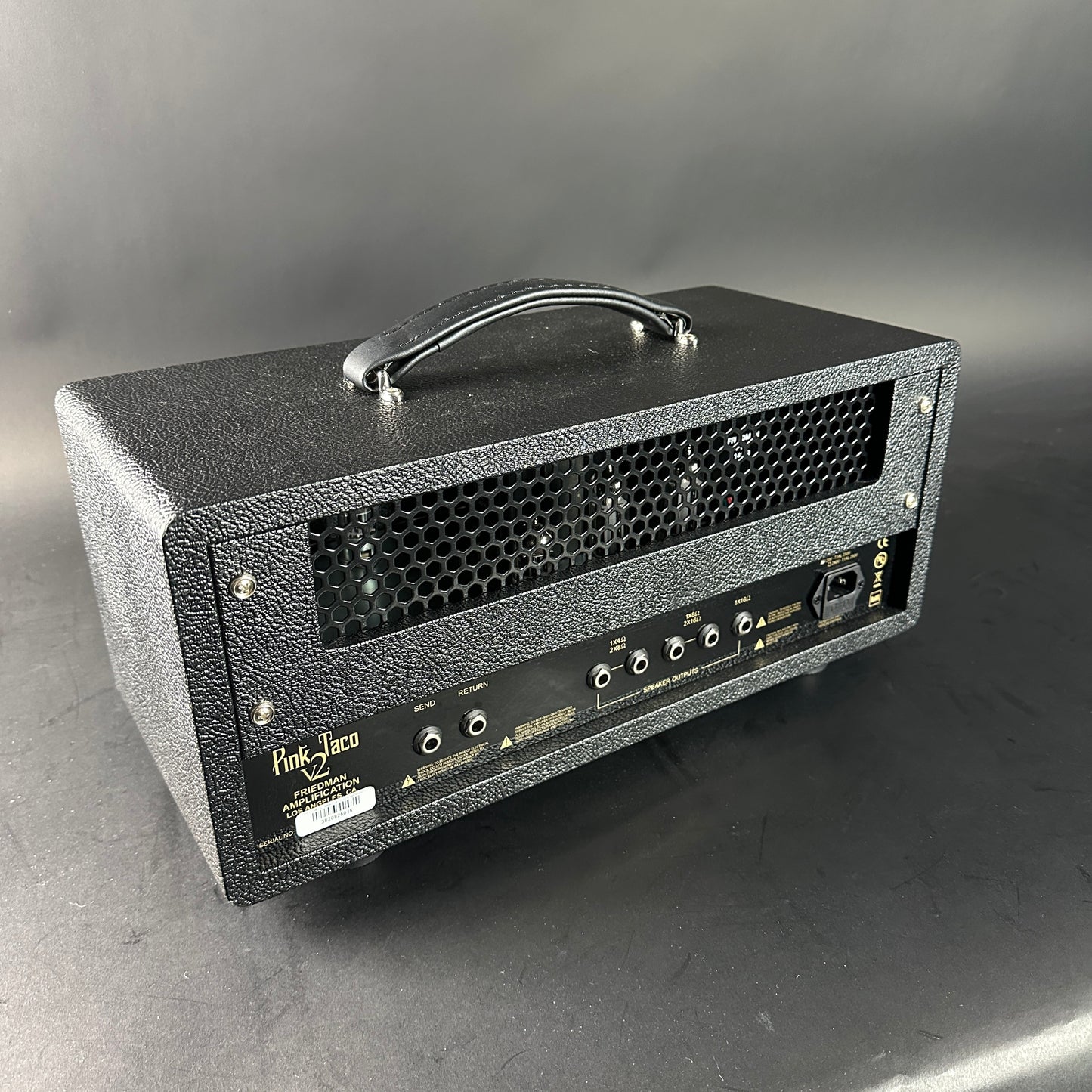 Black guitar amplifier with visible brand name on a gray background