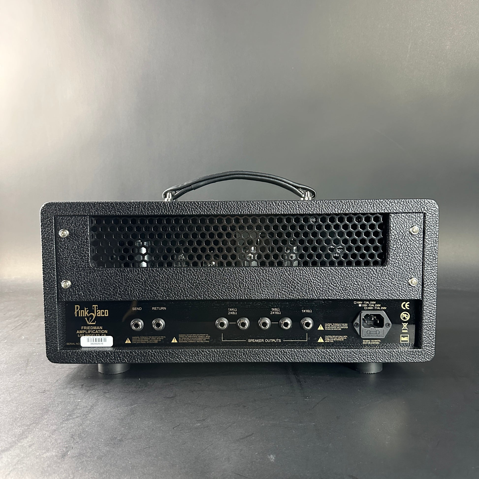 Black guitar amplifier head with visible brand name on a gray background