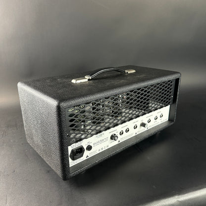 Black guitar amplifier head on a gray background