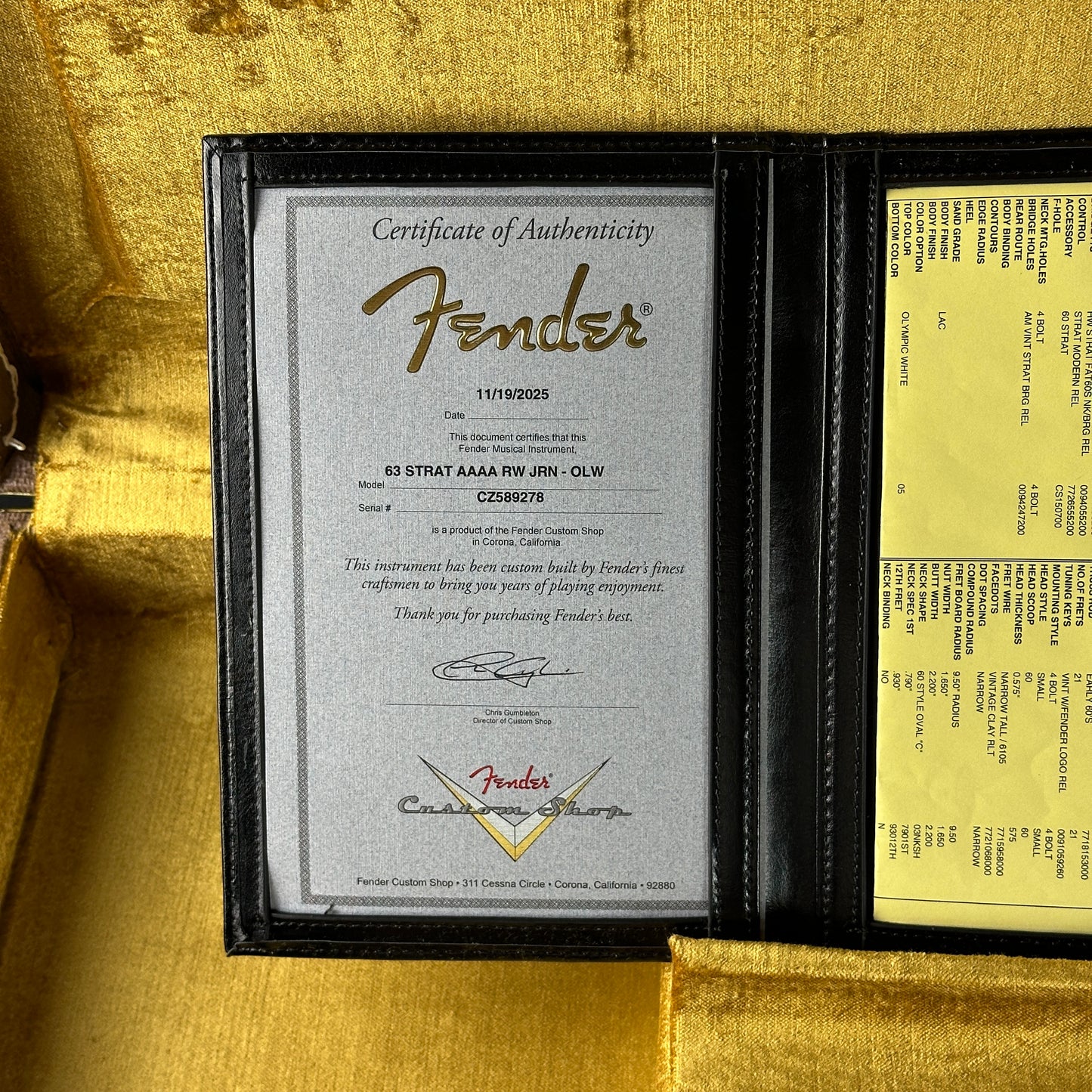 Fender certificate of authenticity inside a guitar case with gold interior.