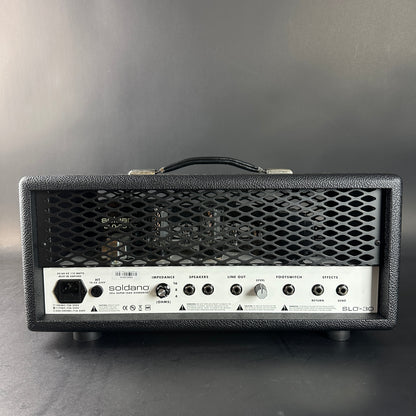 Guitar amplifier head with visible branding on a gray background