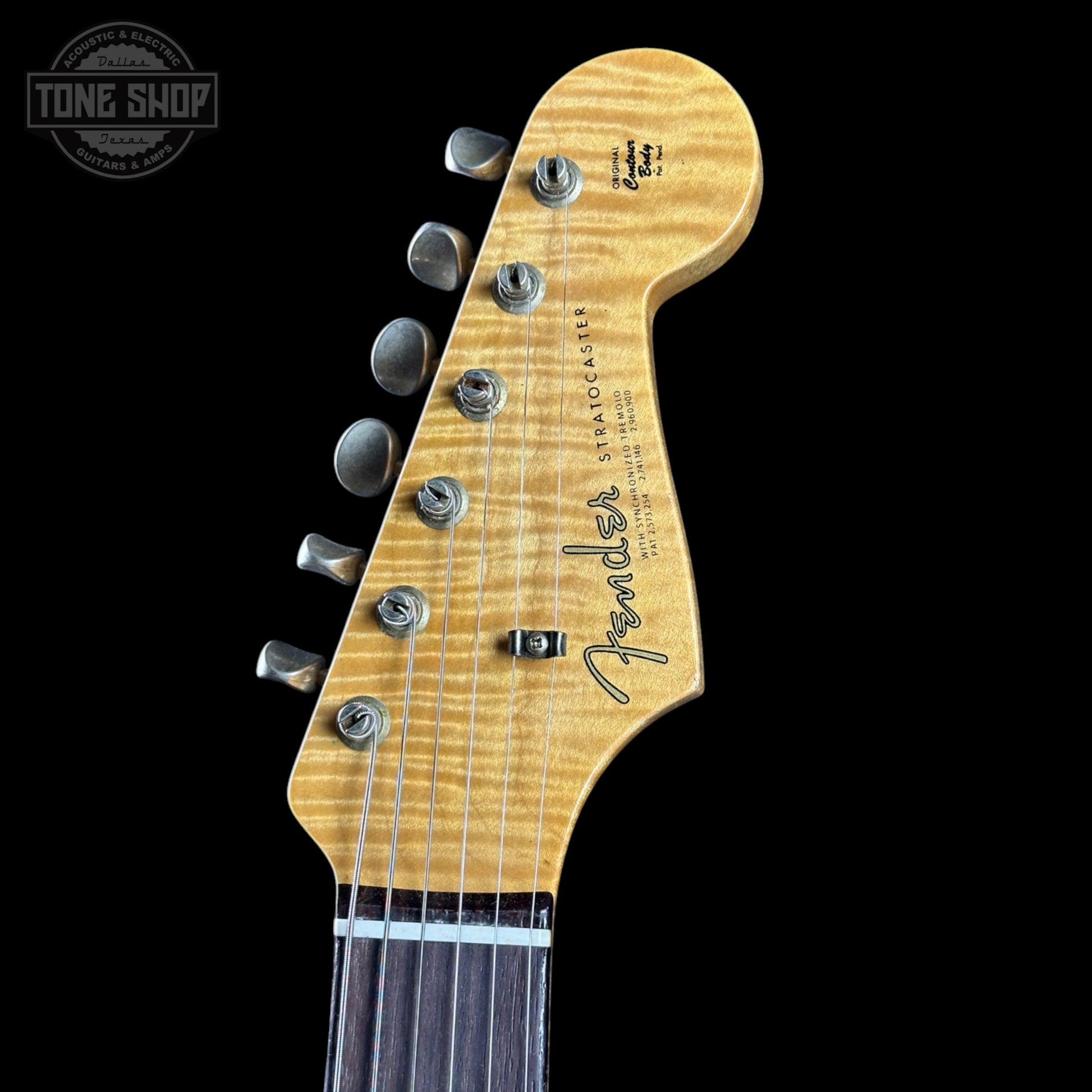 Fender guitar headstock with brand logo on a black background