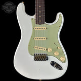 White electric guitar with green pickguard on a black background, featuring 'Tone Shop' branding.