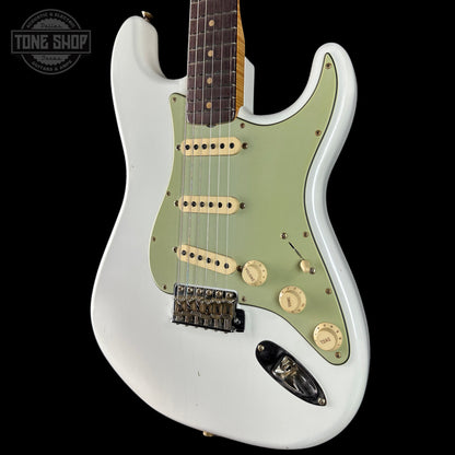 White electric guitar with green pickguard on a black background, featuring 'Tone Shop' logo.