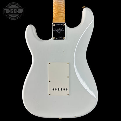 White electric guitar with a visible brand logo on a black background