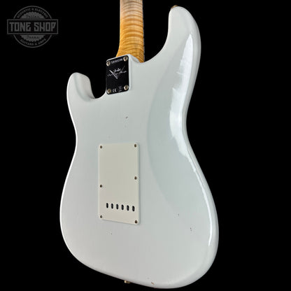 White electric guitar body with a visible brand logo on a black background