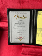Fender certificate of authenticity in a black frame on a red background