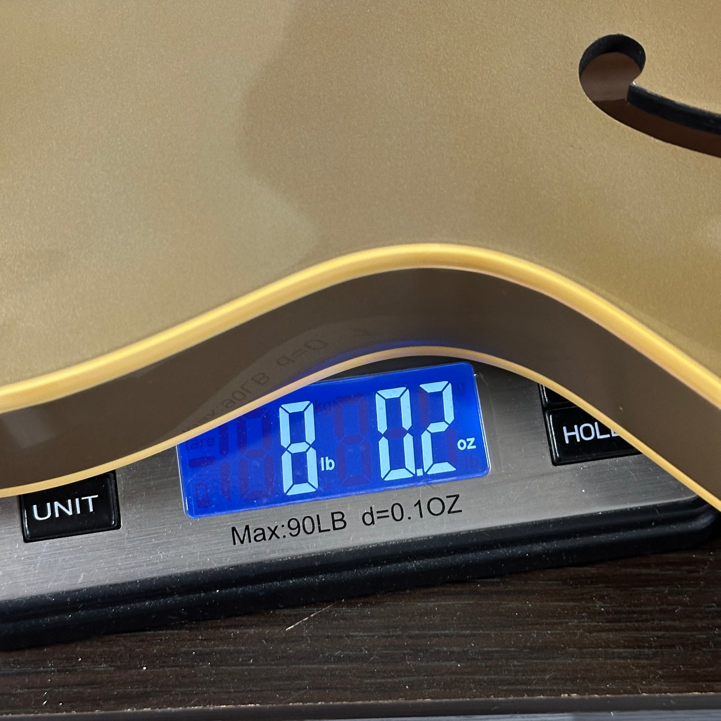 Digital scale displaying weight on a wooden surface