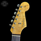 Fender Stratocaster guitar headstock on a black background with 'Tone Shop' logo.