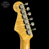 Guitar headstock with tuning pegs on a black background, featuring the Tone Shop logo.