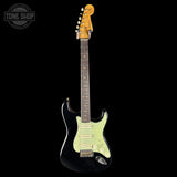 Electric guitar with a black pickguard and light green body on a black background, featuring 'Tone Shop' logo.
