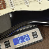Used 2010 Fender Custom Shop 1960 Stratocaster NOS Black Matching Headstock on scale displaying weight.