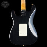 Black electric guitar with a wavy design on the back, brand 'Tone Shop' visible.