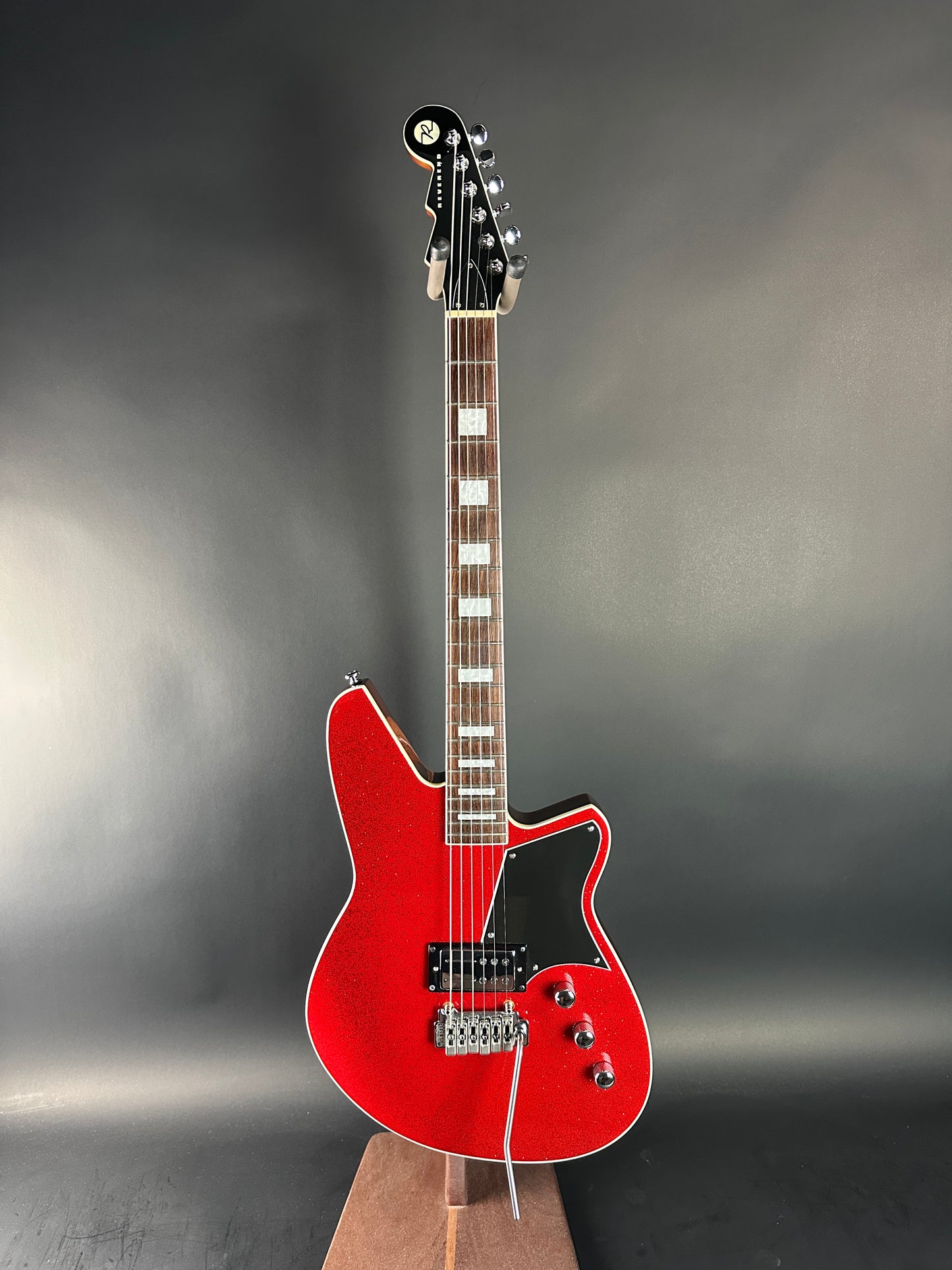 Red electric guitar on a gray background