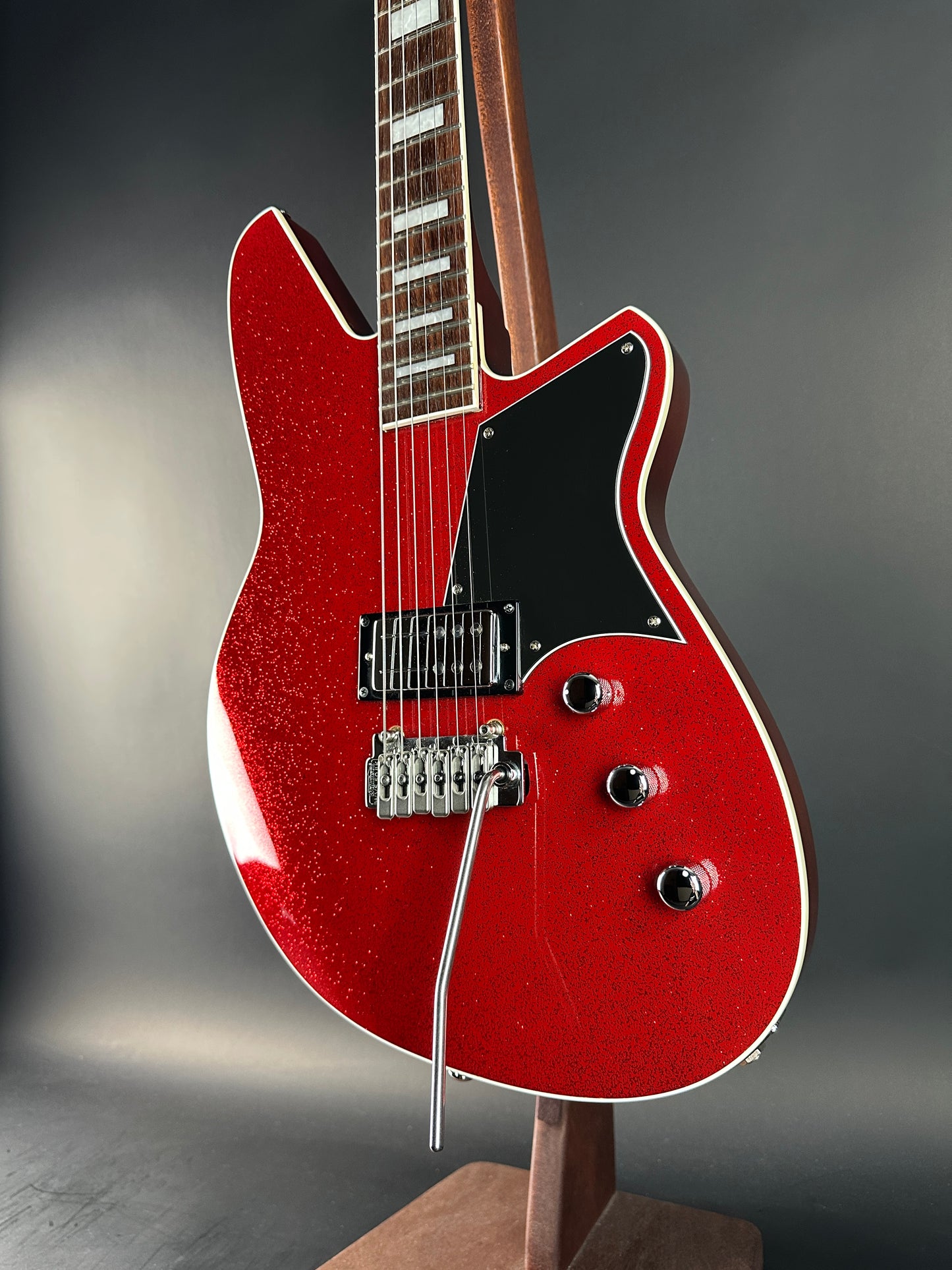 Red electric guitar on a gray background