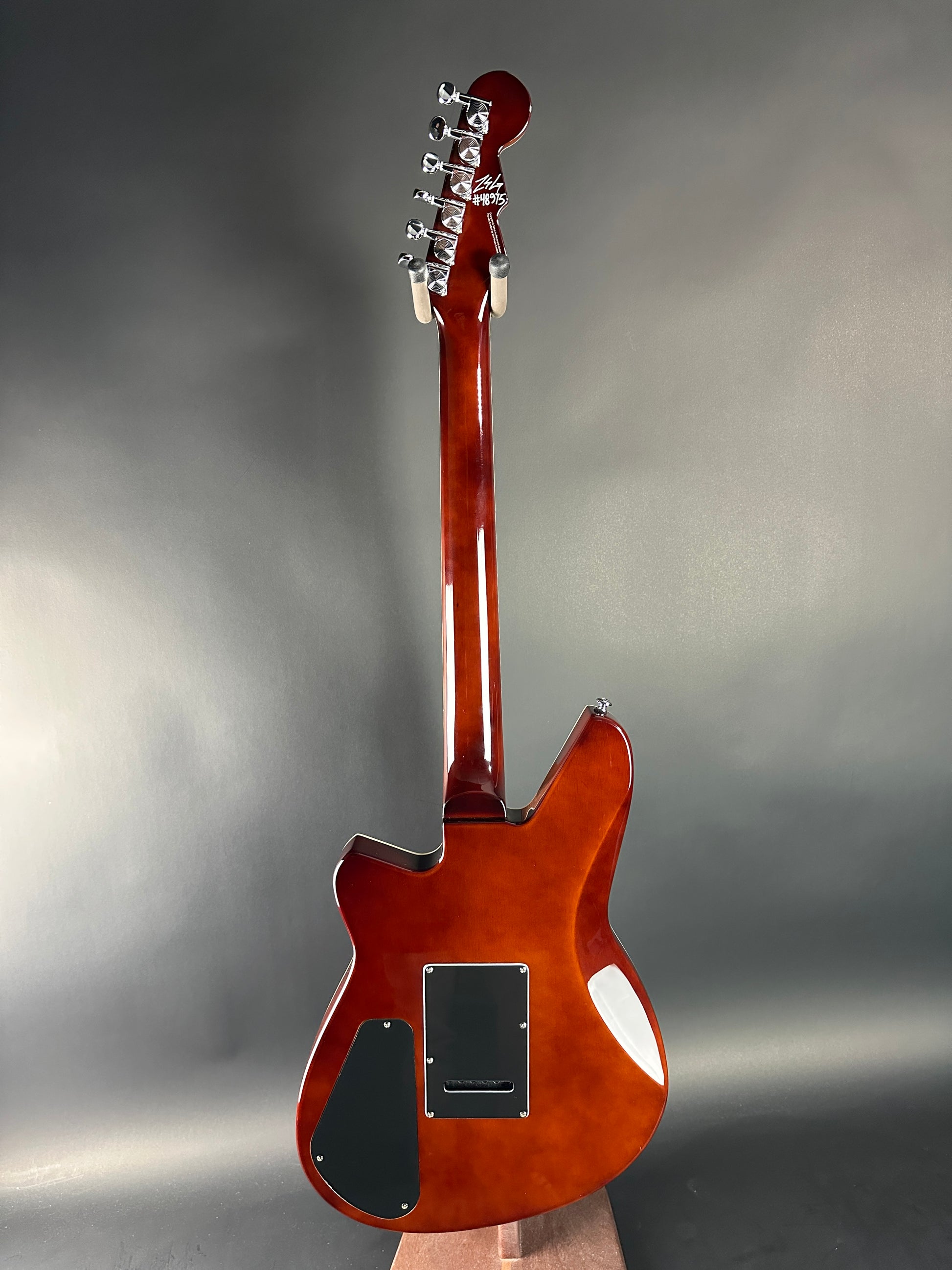 Electric guitar with a sunburst finish on a gray background