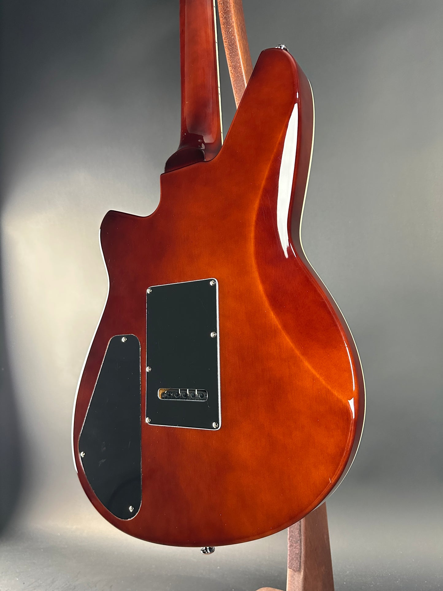 Close-up of a Reverend electric guitar on a gray background