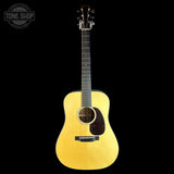 A natural wood acoustic guitar with a dark pickguard and headstock, photographed vertically against a solid black background. A 'TONE SHOP' watermark is visible in the top-left corner.