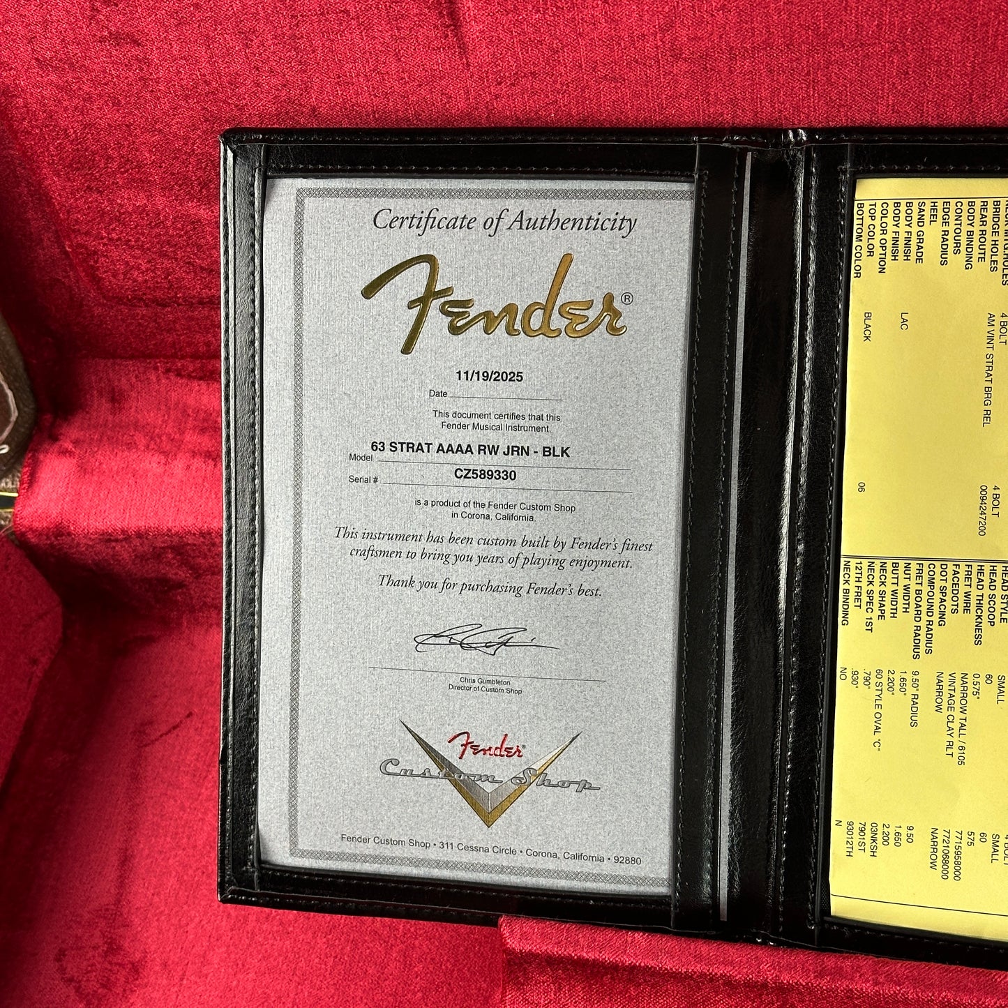 Fender certificate of authenticity in a display case on a red background
