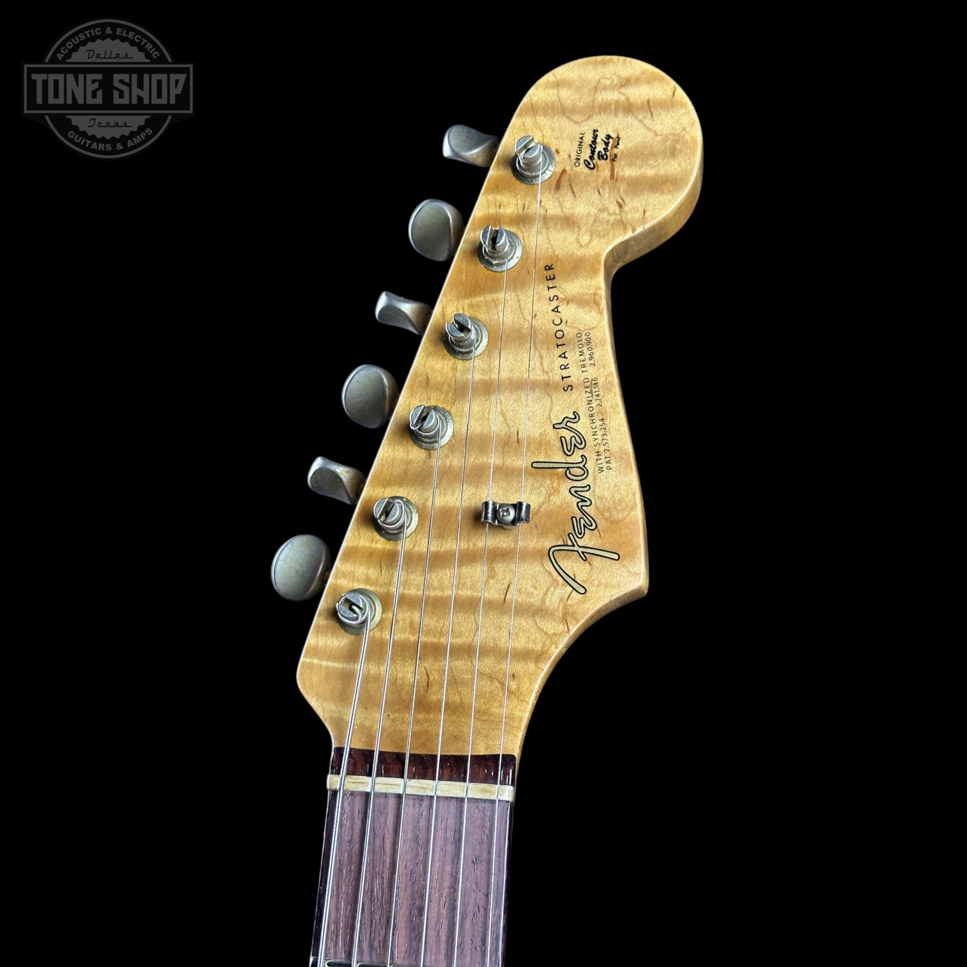 Fender Stratocaster headstock on a black background with 'Tone Shop' logo.