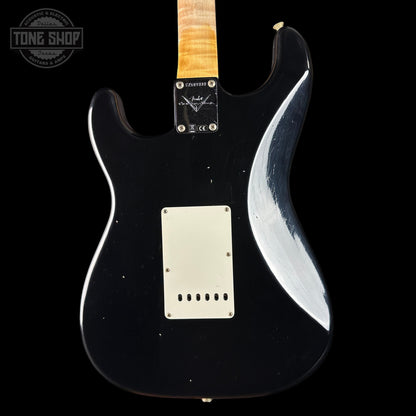 Black electric guitar with a white pickguard on a black background, featuring the Tone Shop logo.