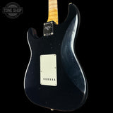 Black electric guitar with a visible brand logo on a black background