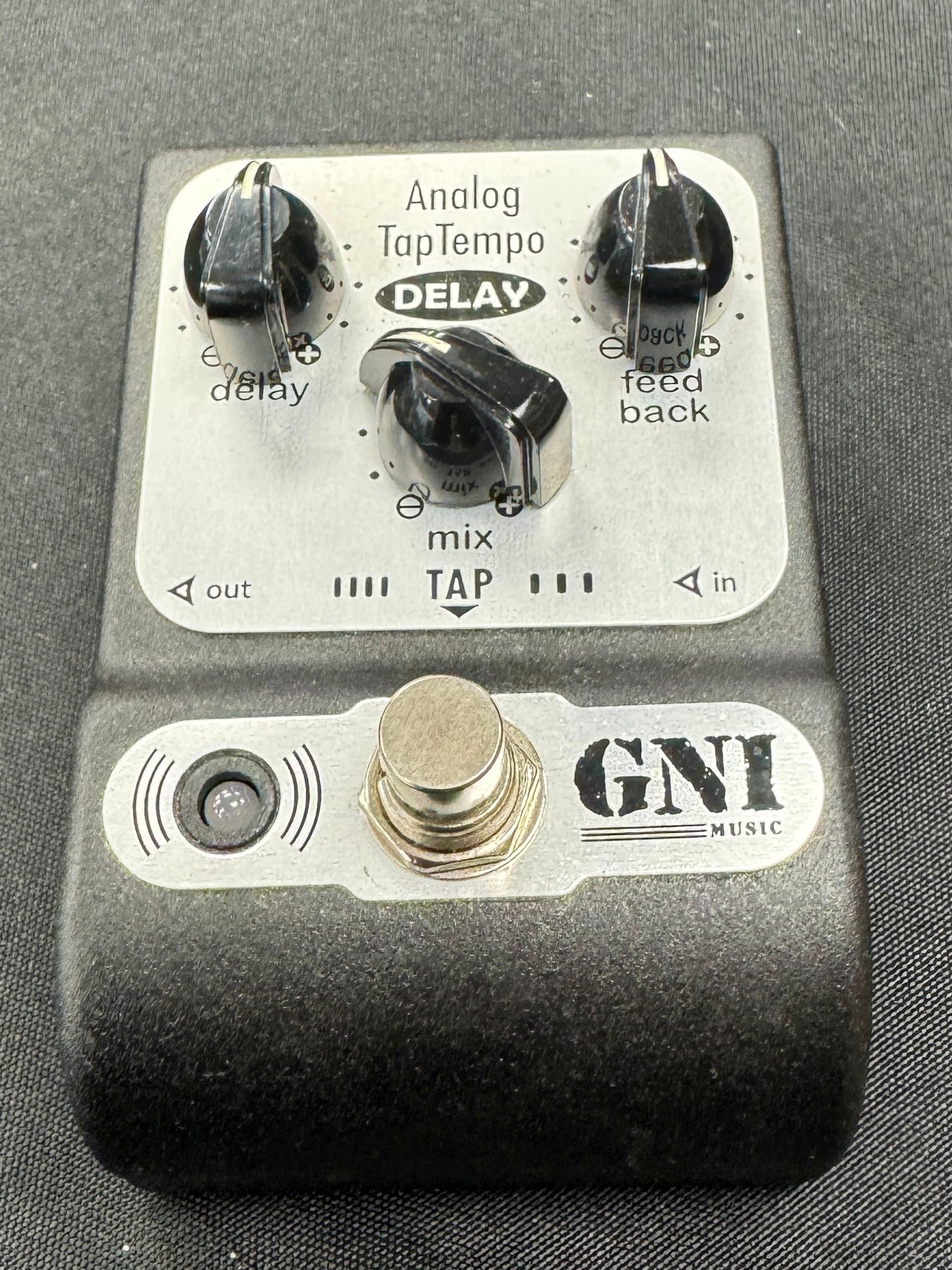 GNI music guitar effects pedal on a gray background