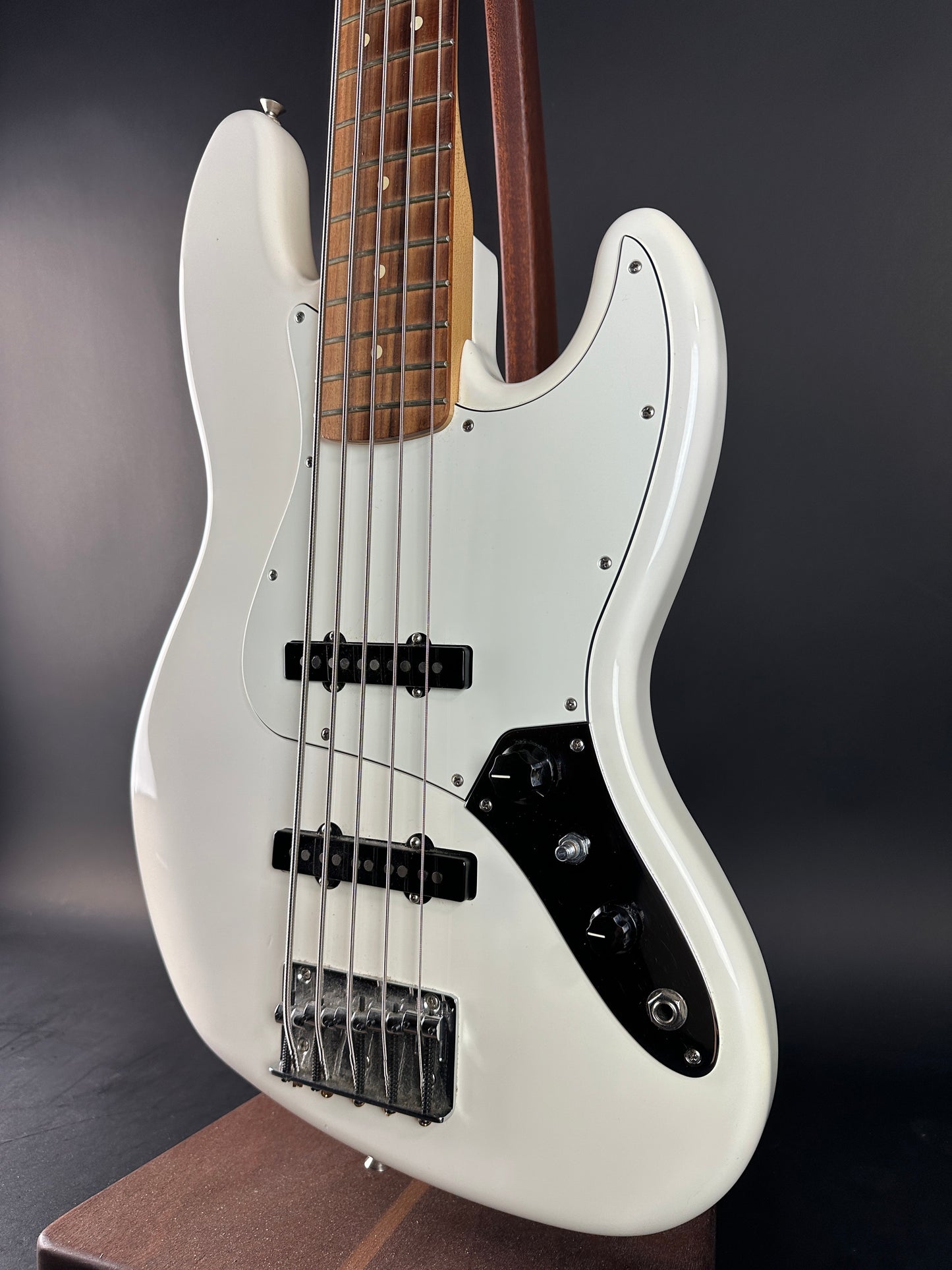 White electric bass guitar on a dark background