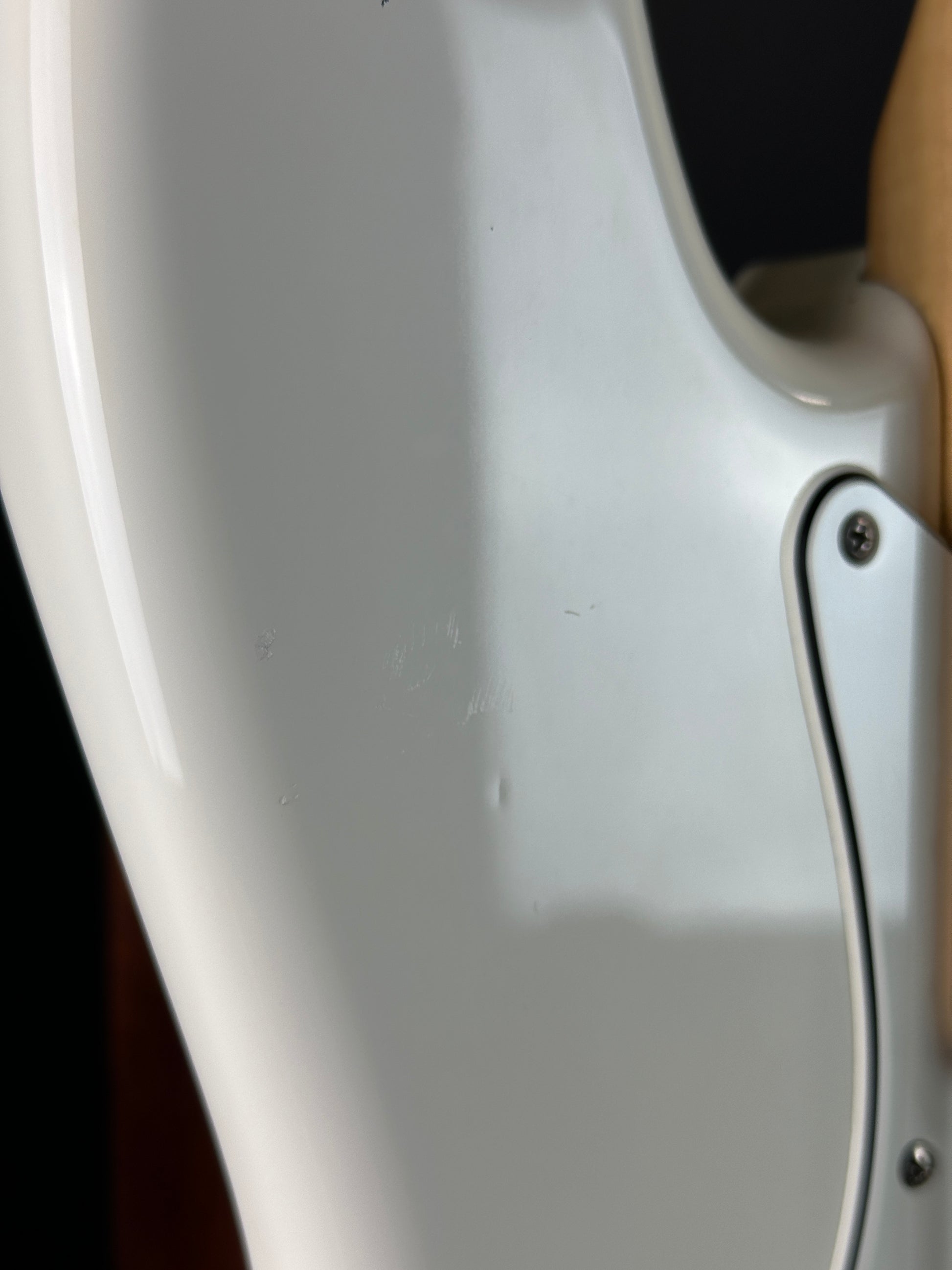 Close-up of a guitar's headstock and tuning pegs.