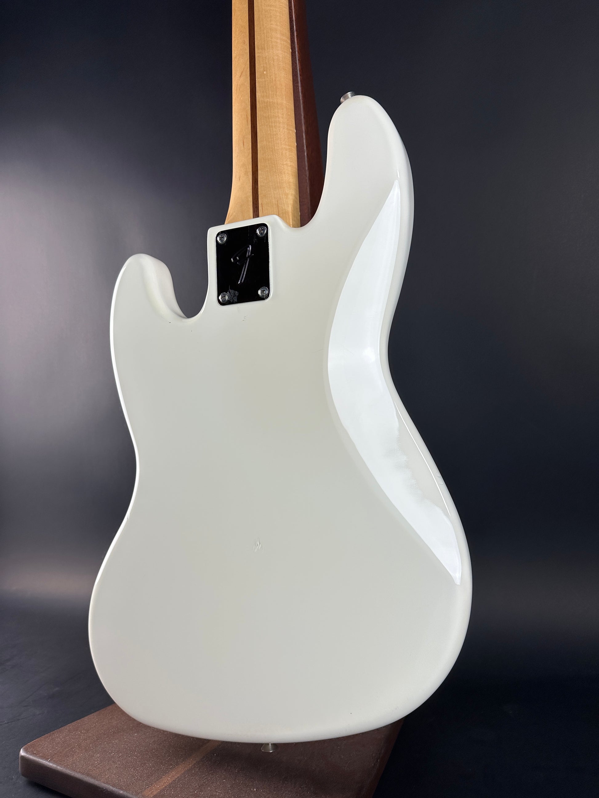 White electric guitar body on a dark background