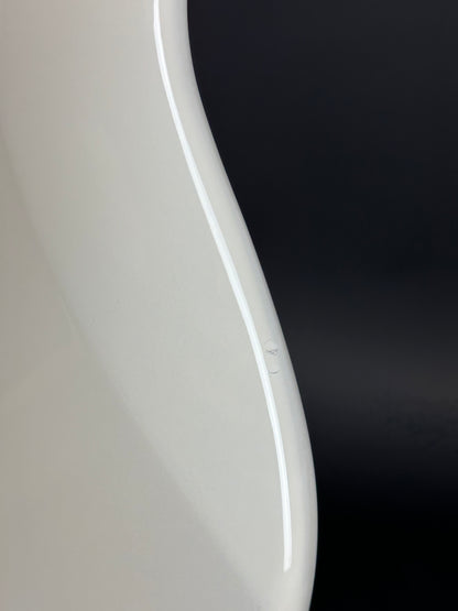 Close-up of a white curved object with a black background