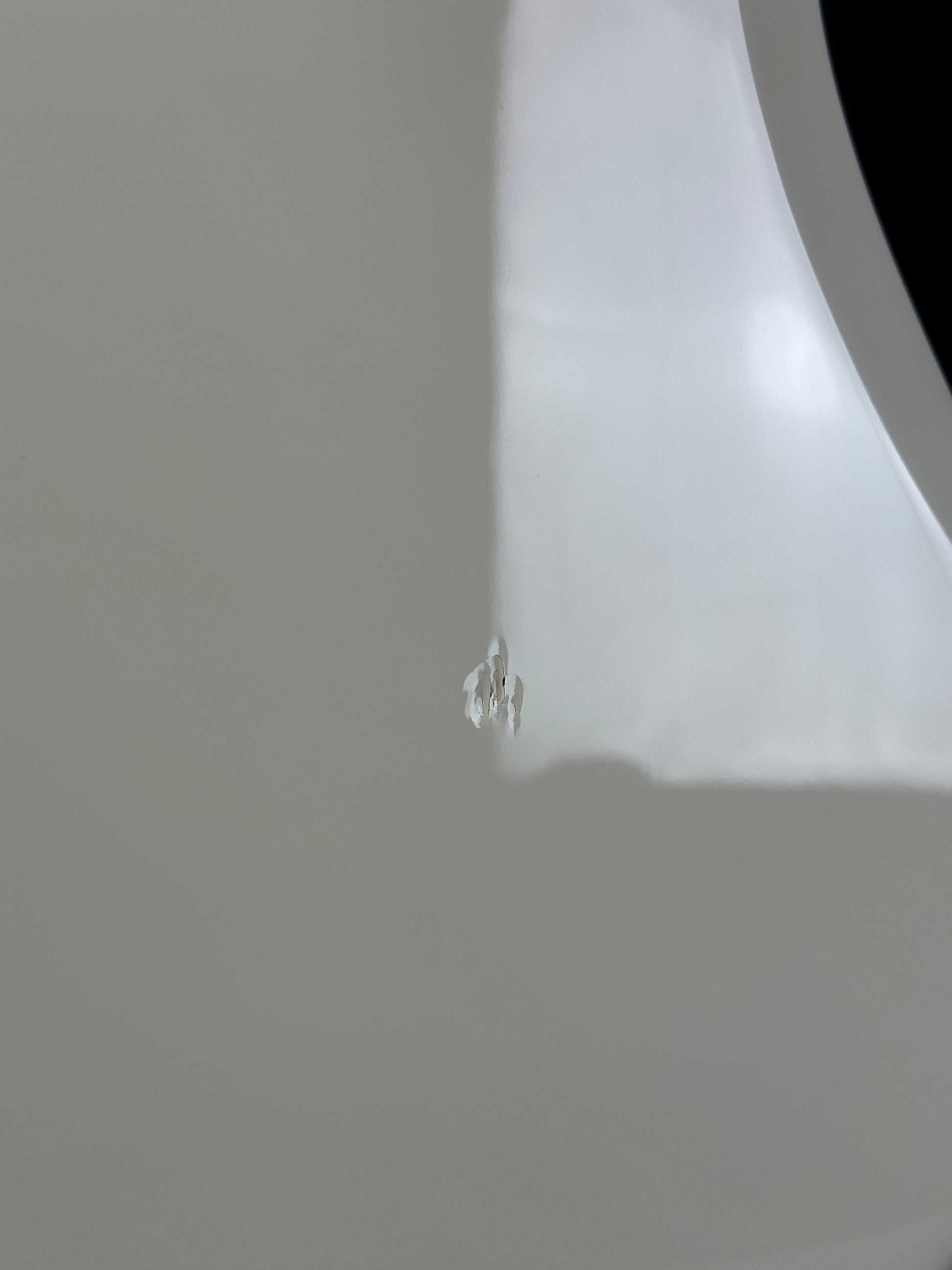 Close-up of a white surface with a subtle reflection