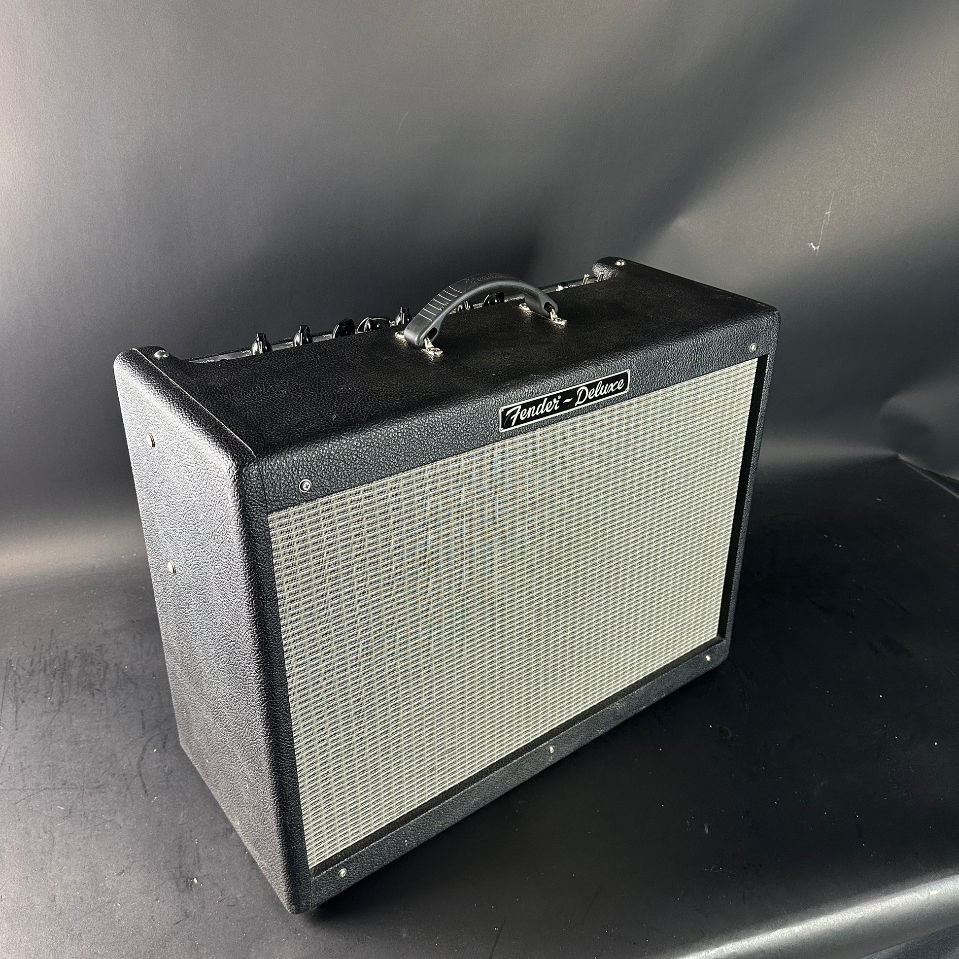 Fender guitar amplifier on a gray surface with a dark background