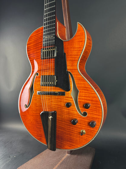 Close-up of a wooden electric guitar on a dark background