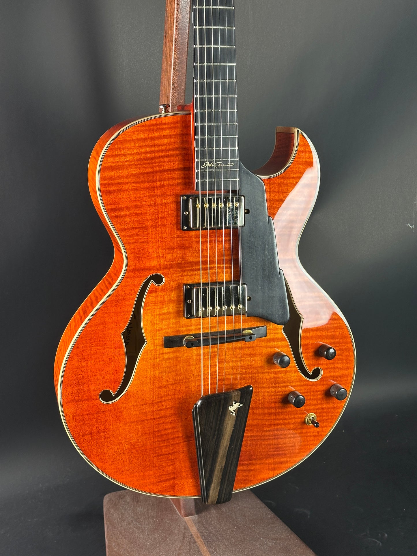 Electric guitar with a wooden finish on a dark background