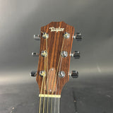 Taylor guitar headstock on a gray background