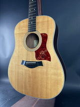 Acoustic guitar with a wooden finish on a dark background