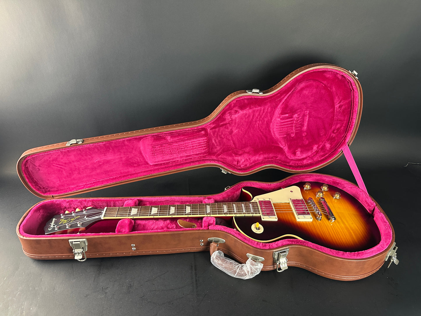 Guitar in an open case on a dark background