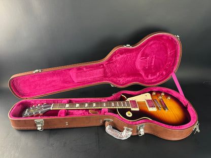 Guitar in an open case on a dark background