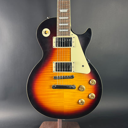 Electric guitar with sunburst finish on a gray background